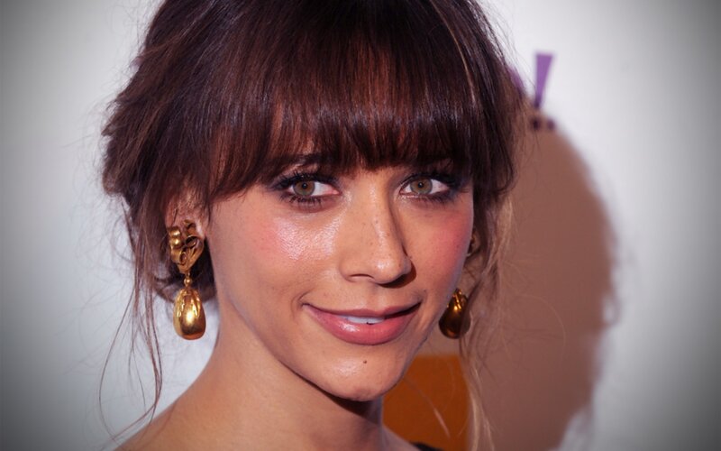 woman with bangs and gold earrings