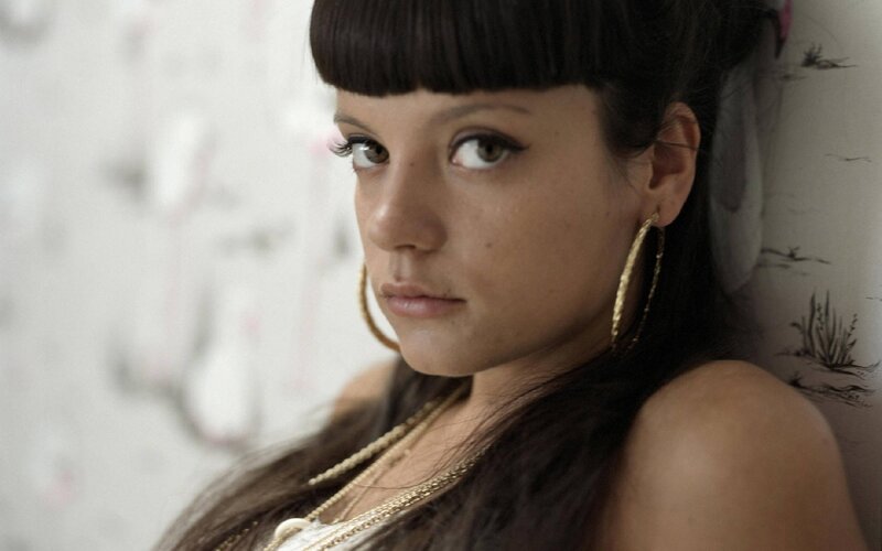woman with bangs and hoop earrings
