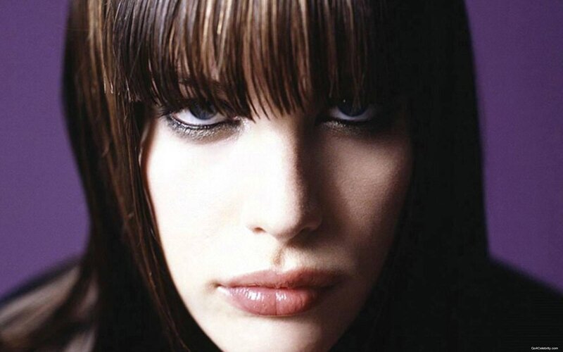 woman with bangs and purple background