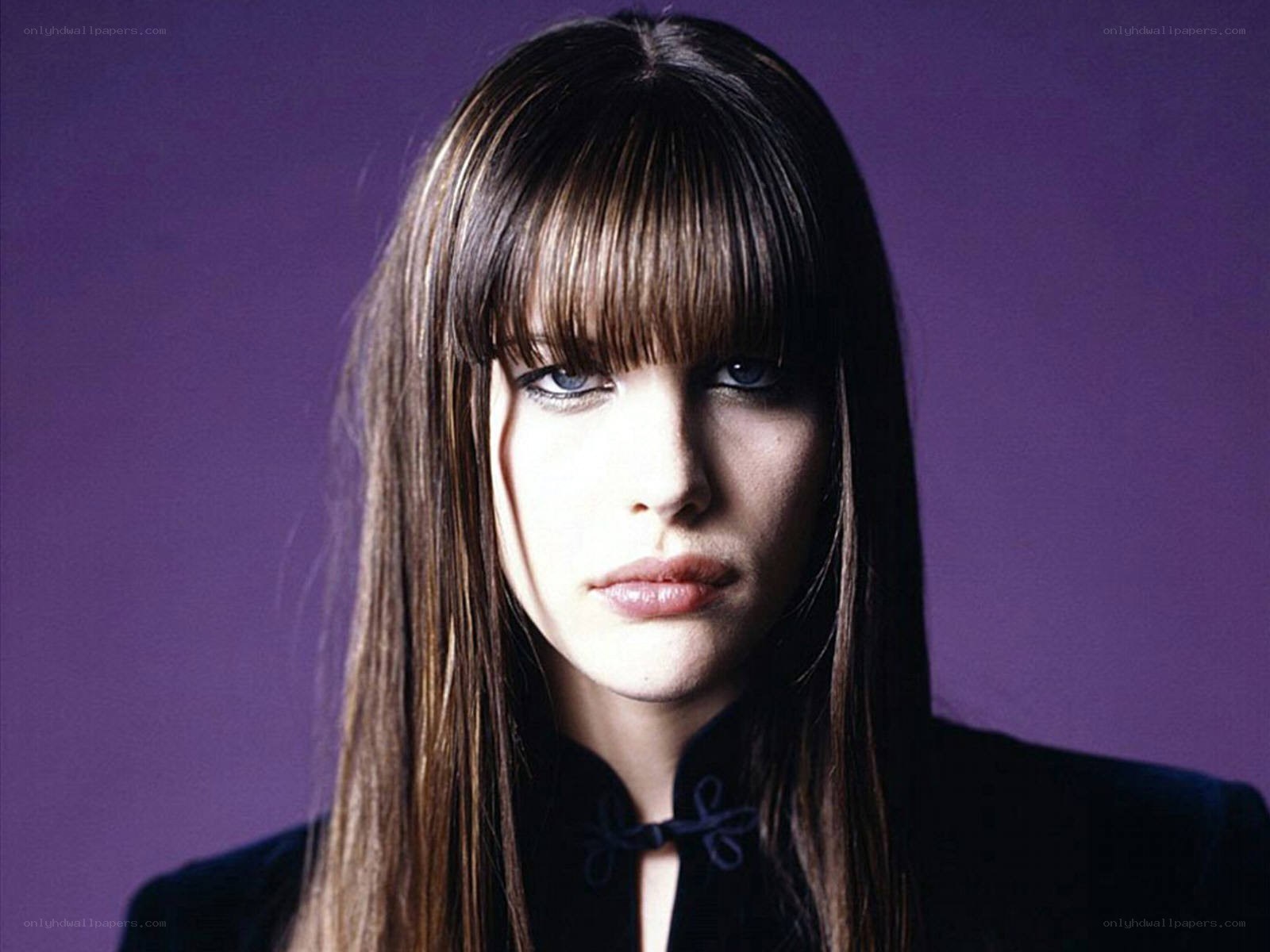 woman with bangs and purple background