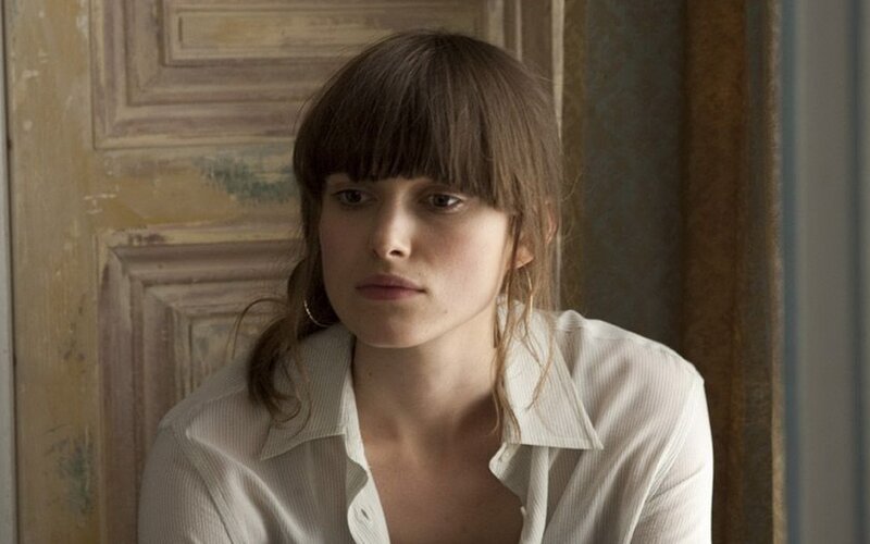 woman with bangs in white shirt
