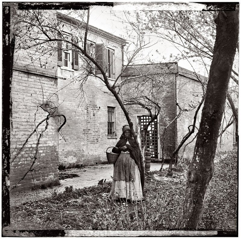 Woman with basket in courtyard