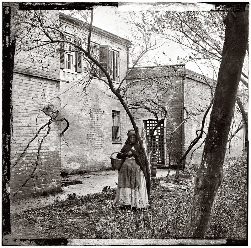 Woman with basket in courtyard