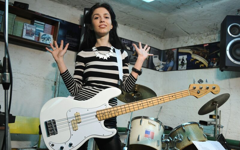 Woman with bass guitar in studio