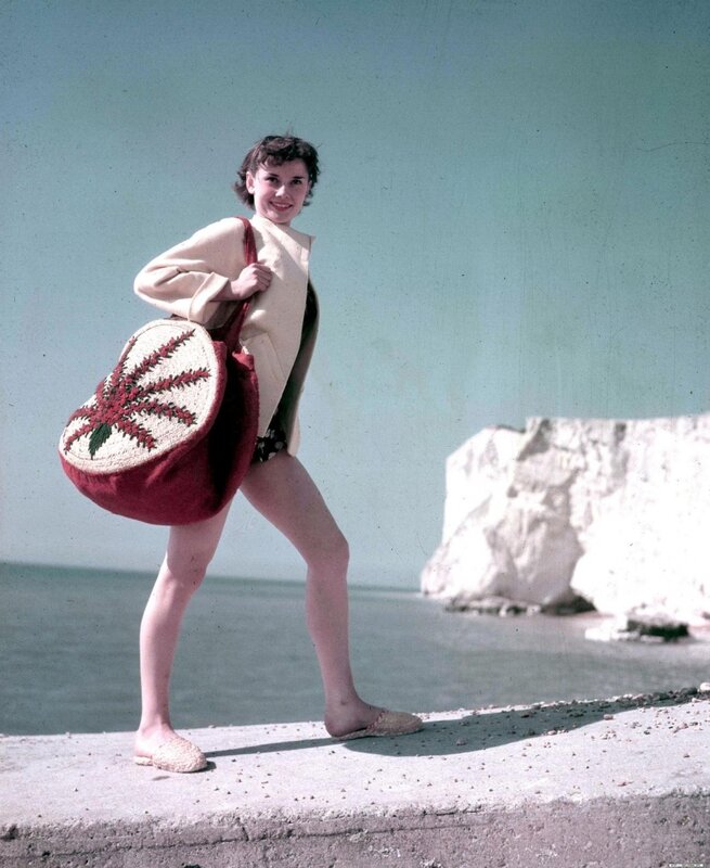 Woman with beach bag at seaside
