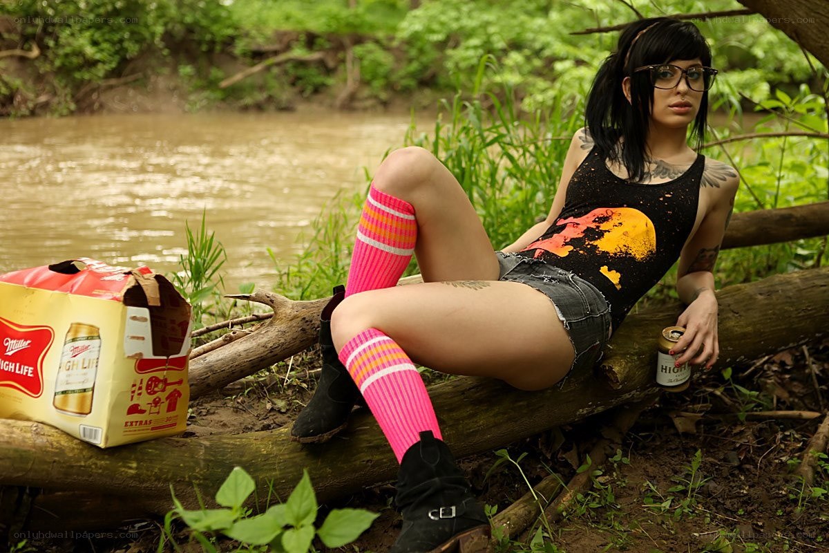 Woman with beer by a river
