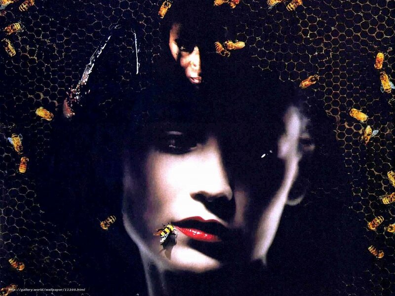 woman with bees on honeycomb