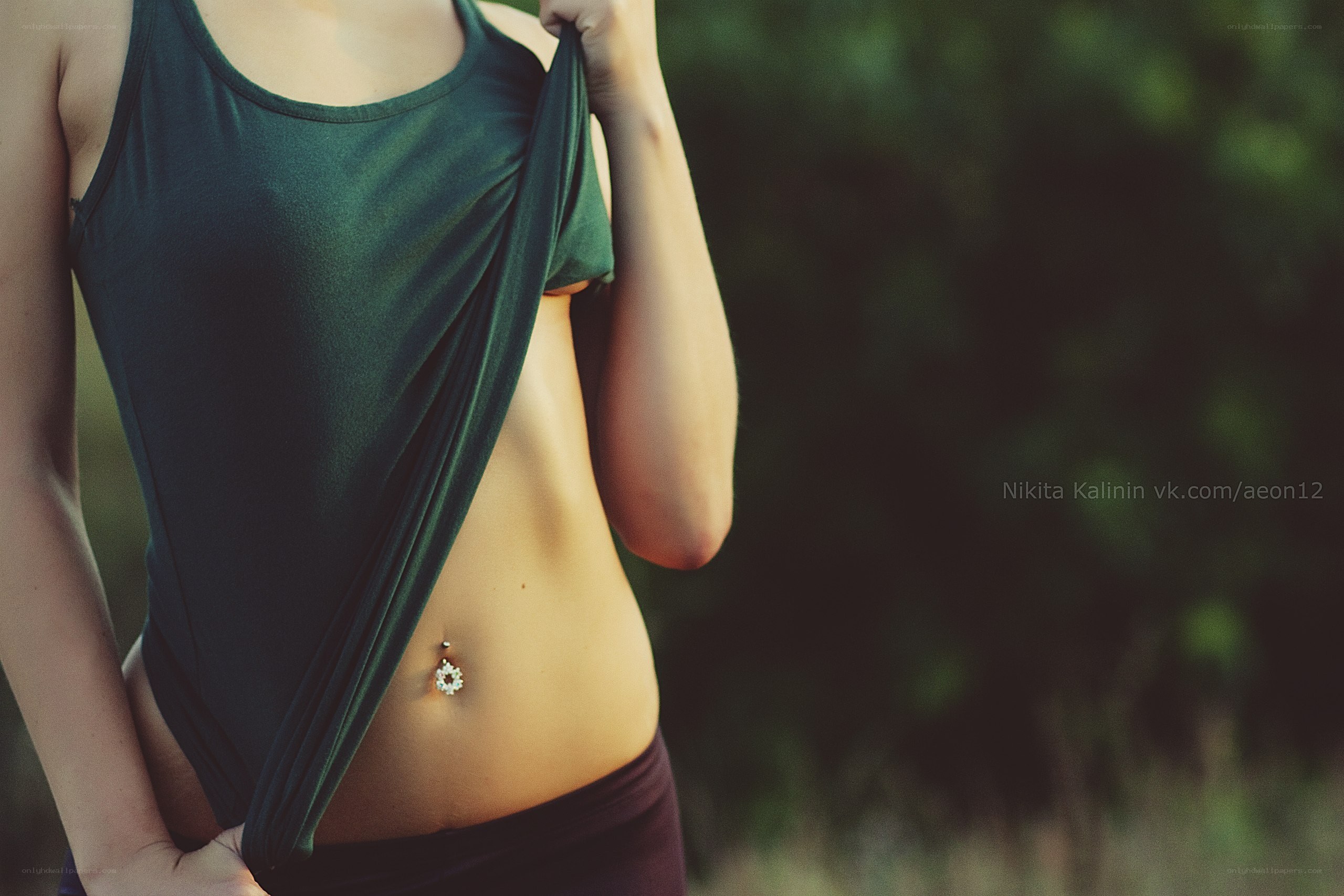 woman with belly button piercing