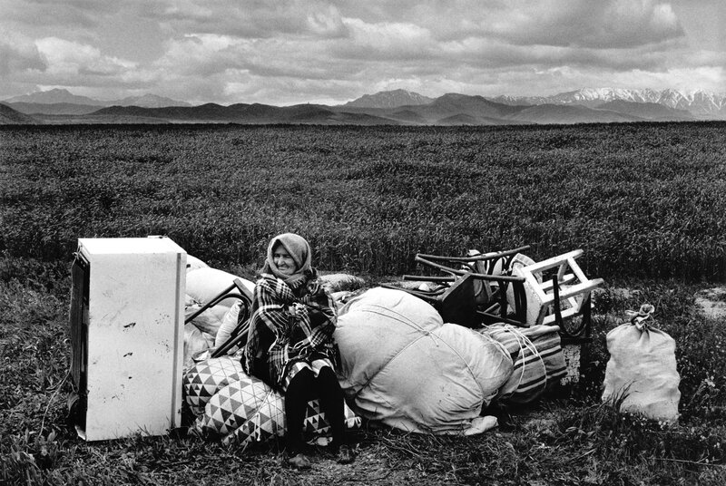 Woman with belongings in a field
