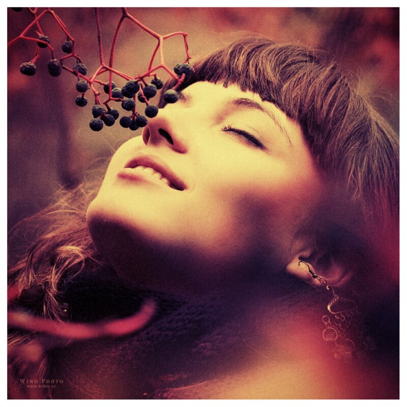 woman with berries above face