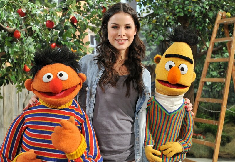 Woman with Bert and Ernie puppets