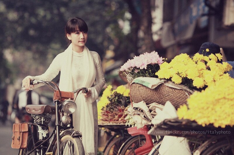 woman with bicycle and flowers