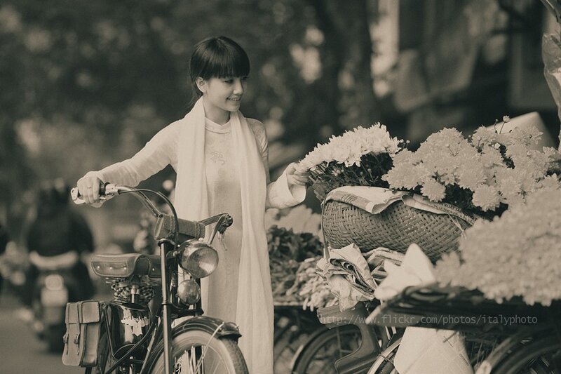 Woman with bicycle and flowers
