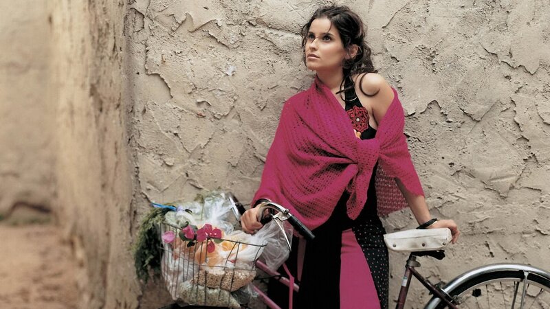 Woman with bicycle and flowers