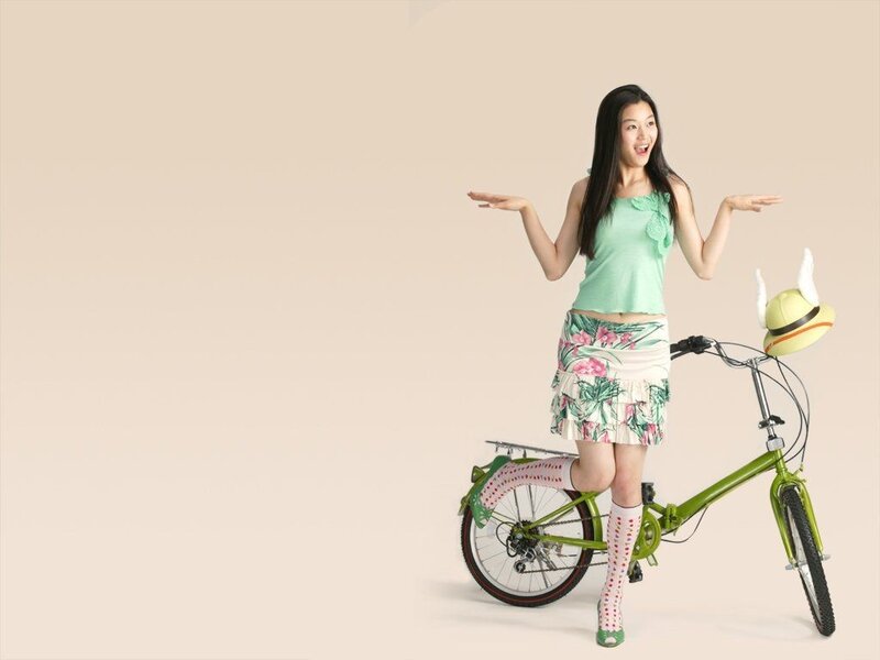 woman with bicycle and hat