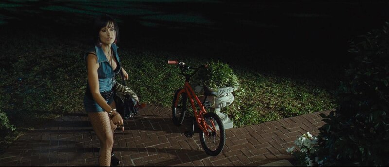 Woman with bicycle at night