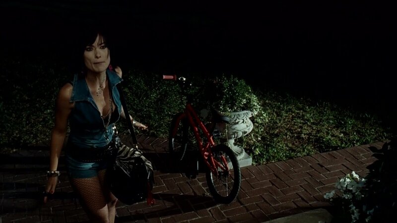 Woman with bicycle at night