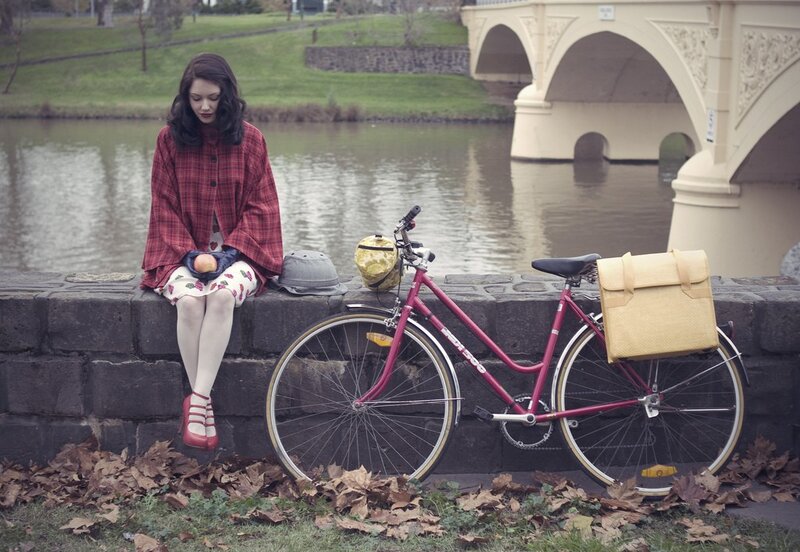 Woman with bicycle by river