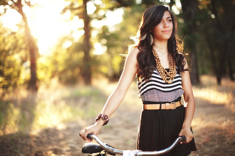 woman with bicycle in forest