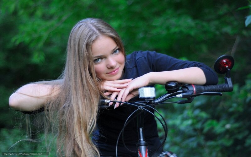 woman with bicycle in forest