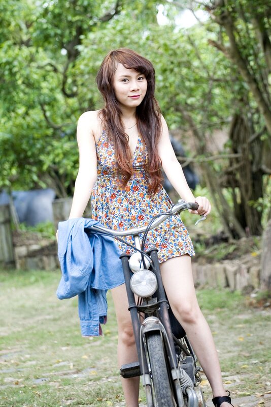woman with bicycle in garden