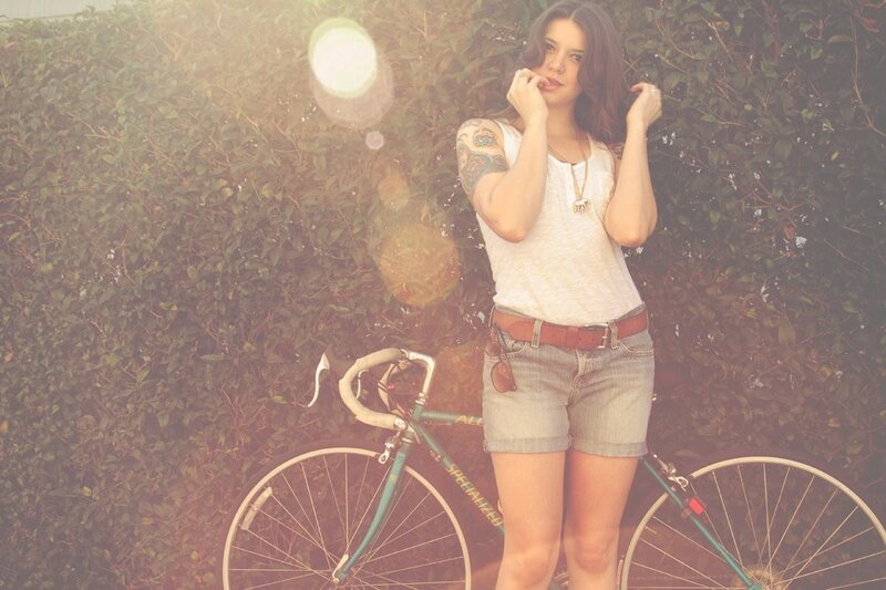 Woman with bicycle in garden