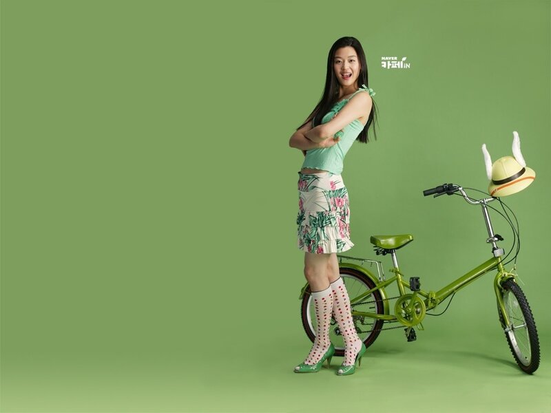 woman with bicycle in green