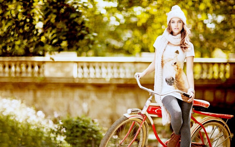Woman with bicycle in park