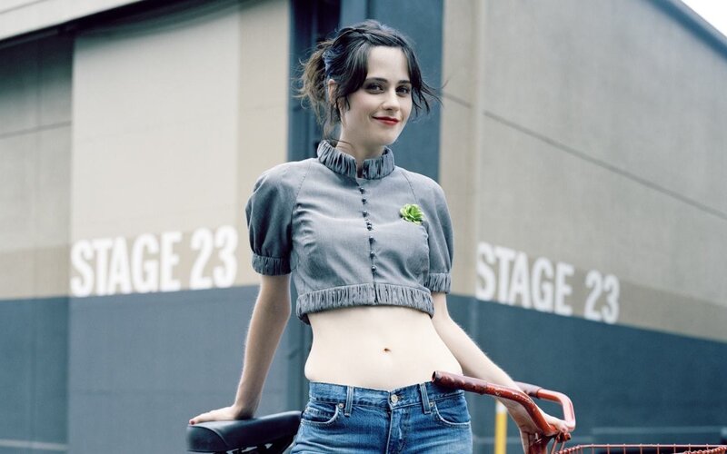 Woman with bicycle near stage