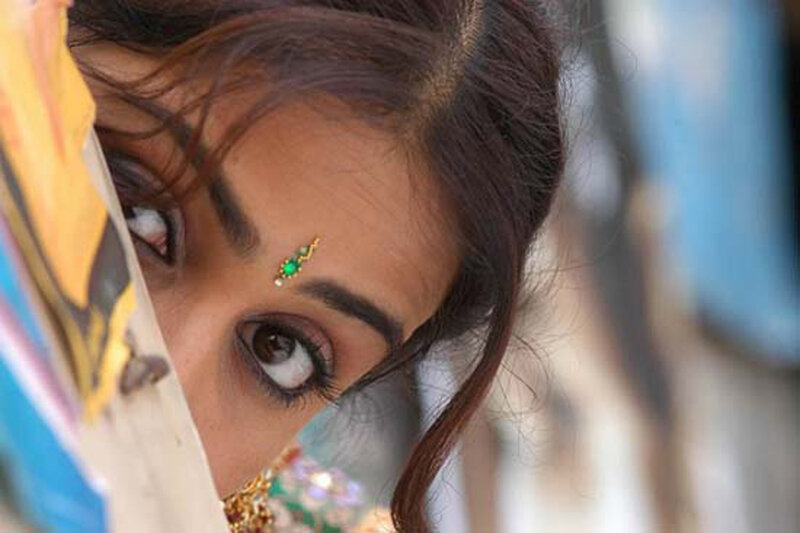 woman with bindi peeking from behind