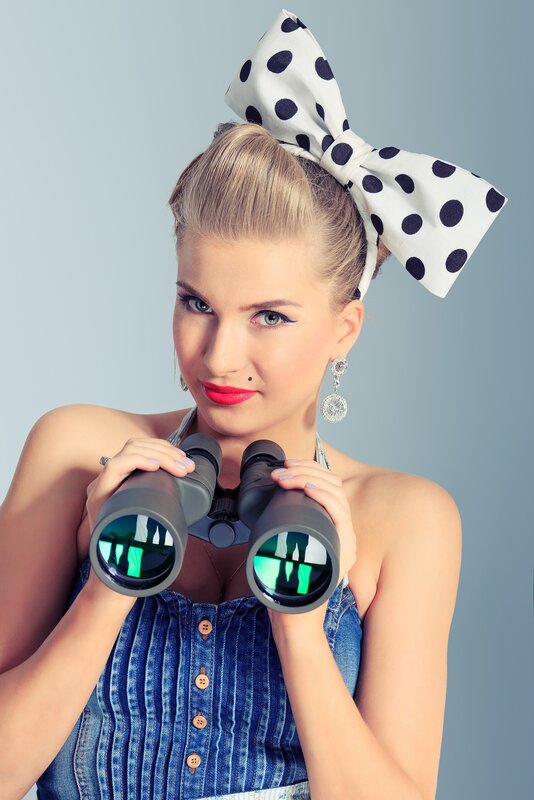 Woman with binoculars and polka-dot bow