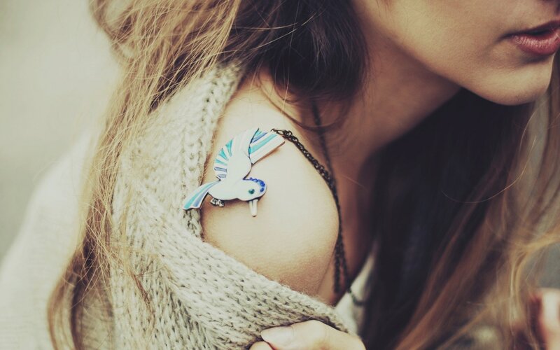 woman with bird brooch