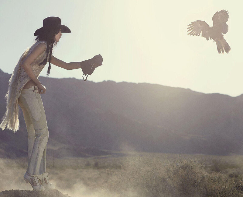 Woman with Bird in Desert