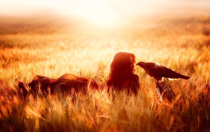 Woman with Bird in Field — Gold
