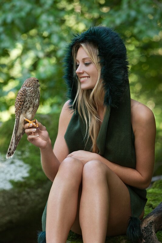 Woman with bird in forest
