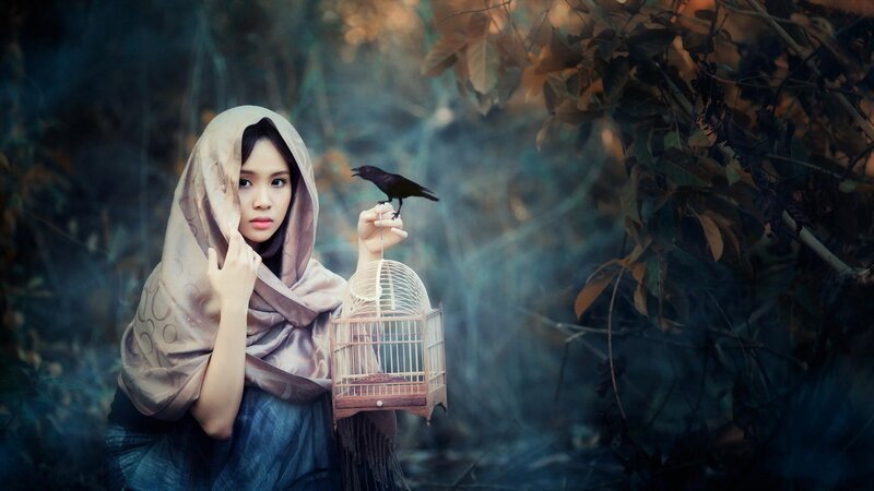 woman with bird in forest
