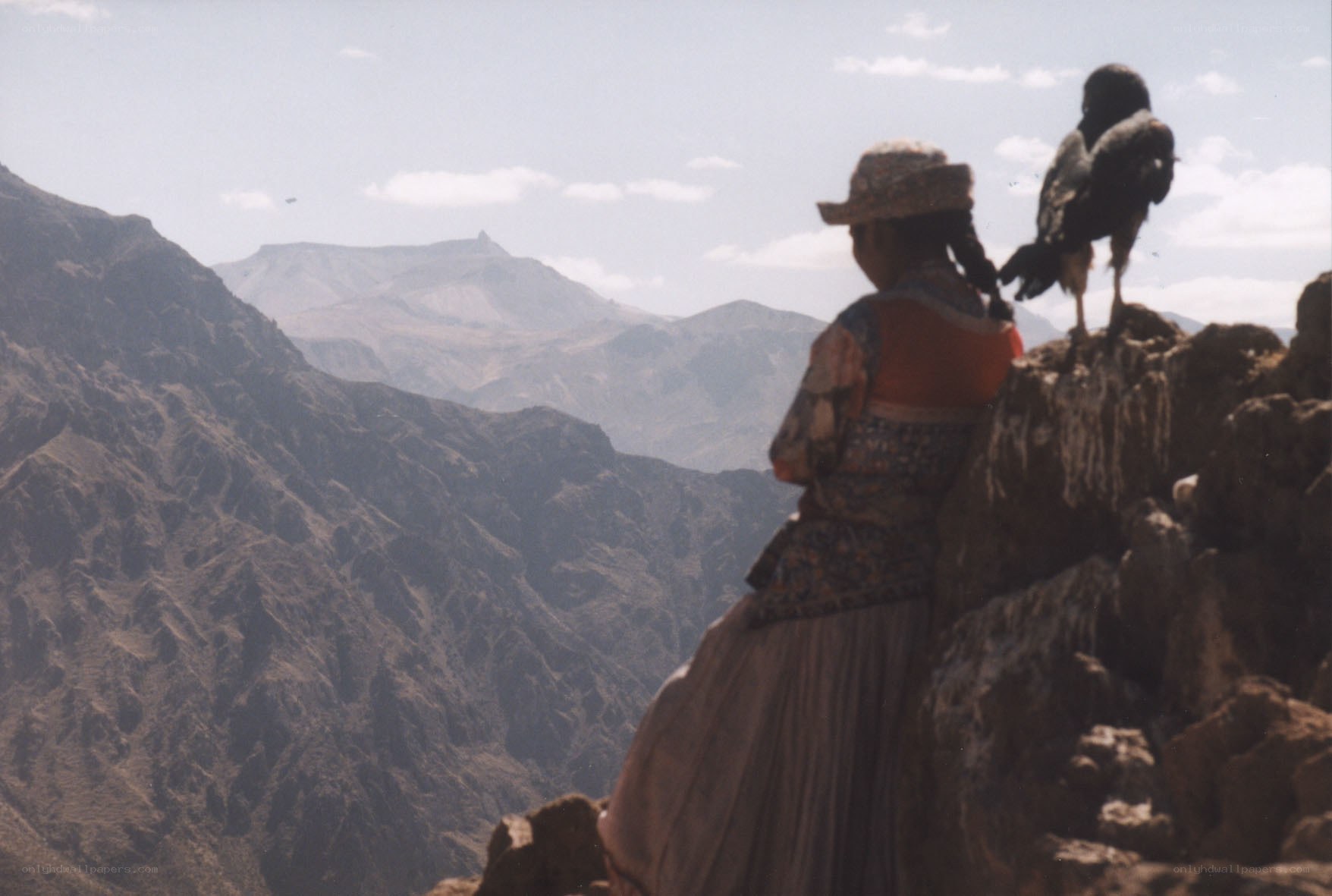 Woman with bird on mountain