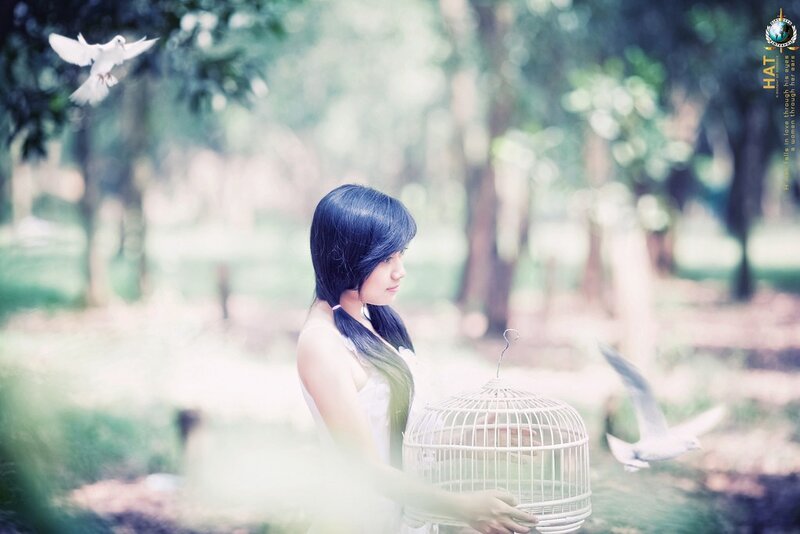 Woman with birdcage in park