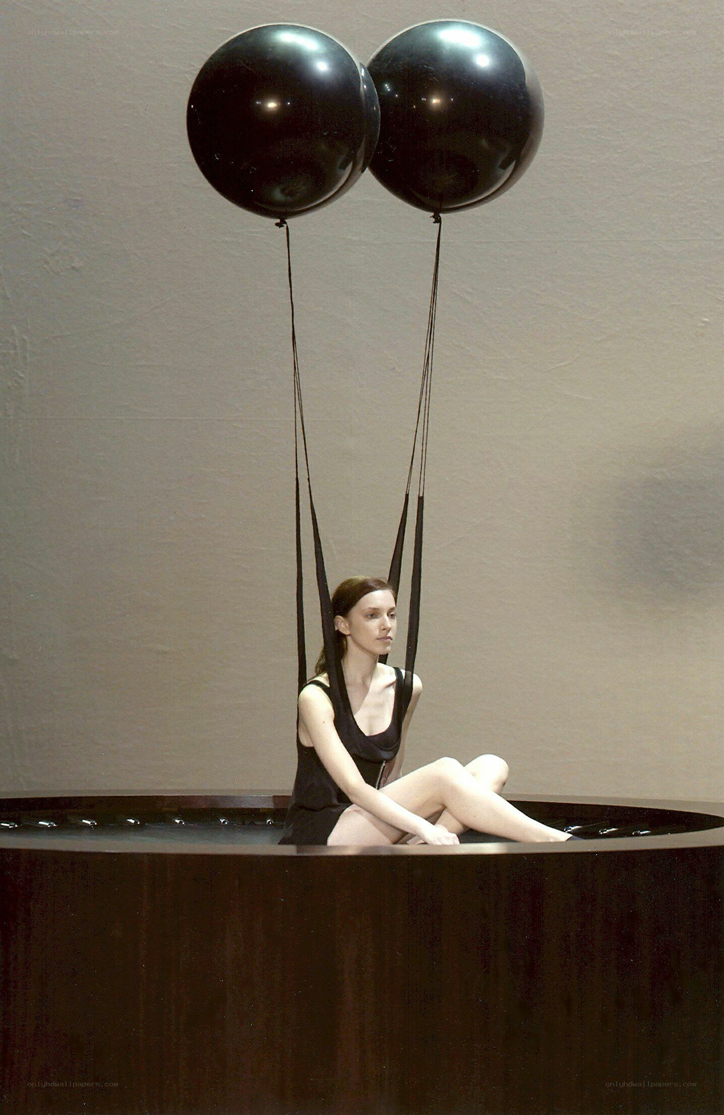 woman with black balloons