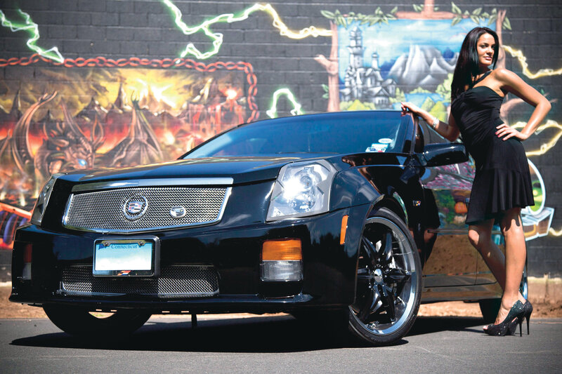 Woman with Black Car — Dramatic, Afternoon, Photograph, Graffiti Wall, High Heels