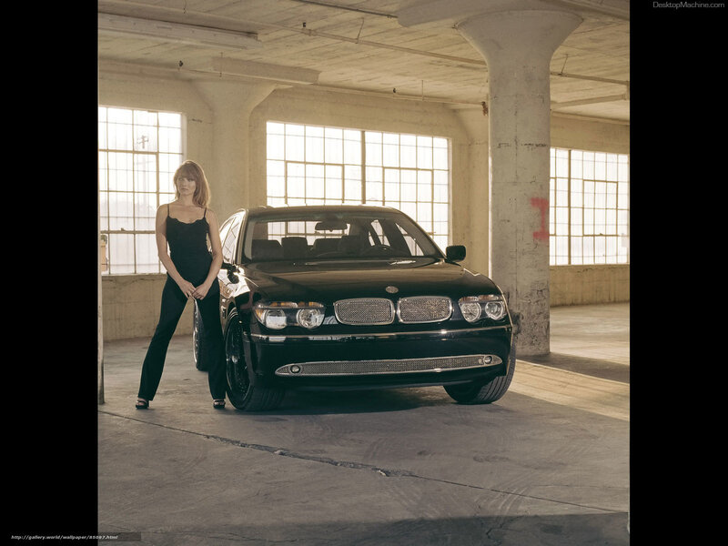 woman with black car in warehouse