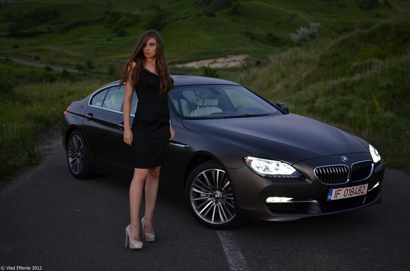 Woman with black car on road