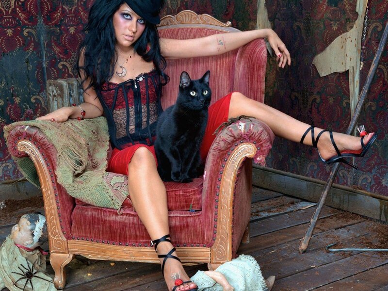 woman with black cat on armchair