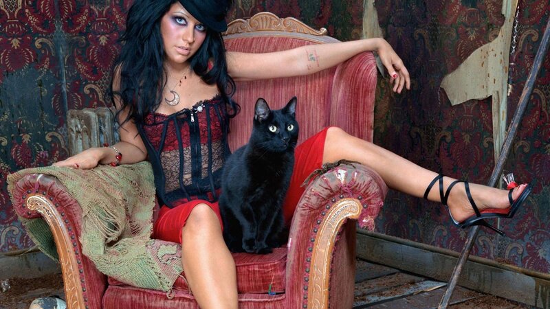 Woman with black cat on chair