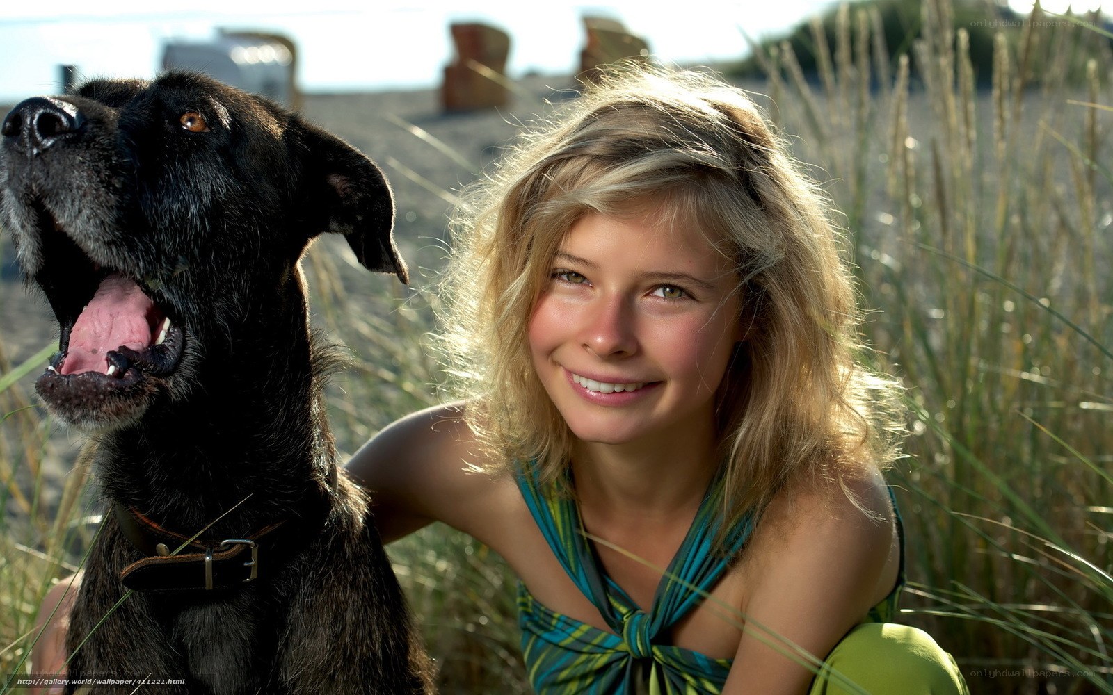 woman with black dog on beach