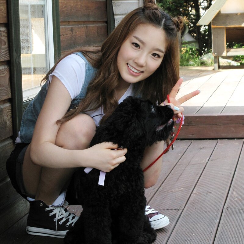 woman with black dog on deck