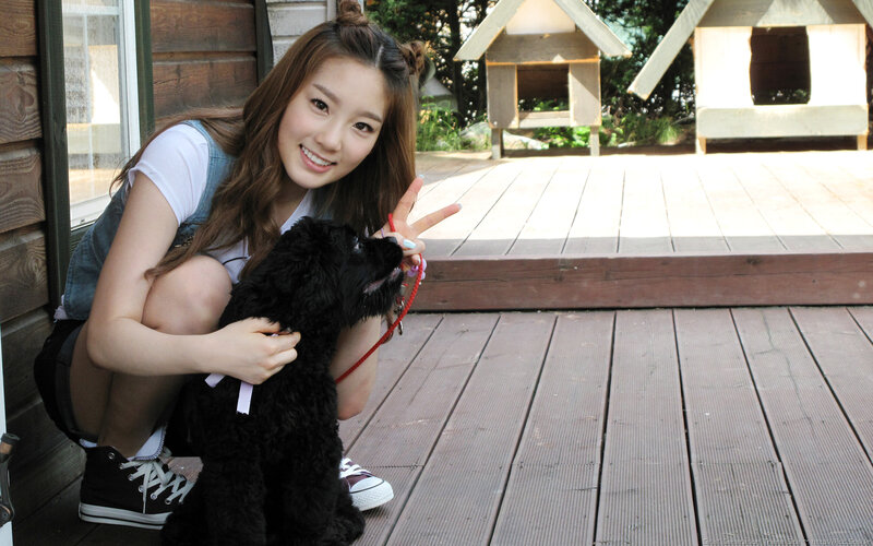 woman with black dog on deck
