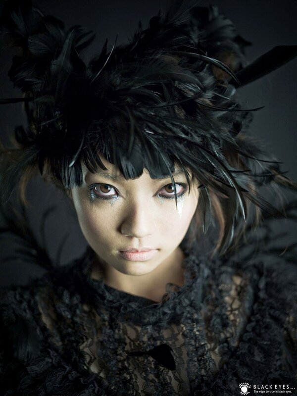 woman with black feather headpiece
