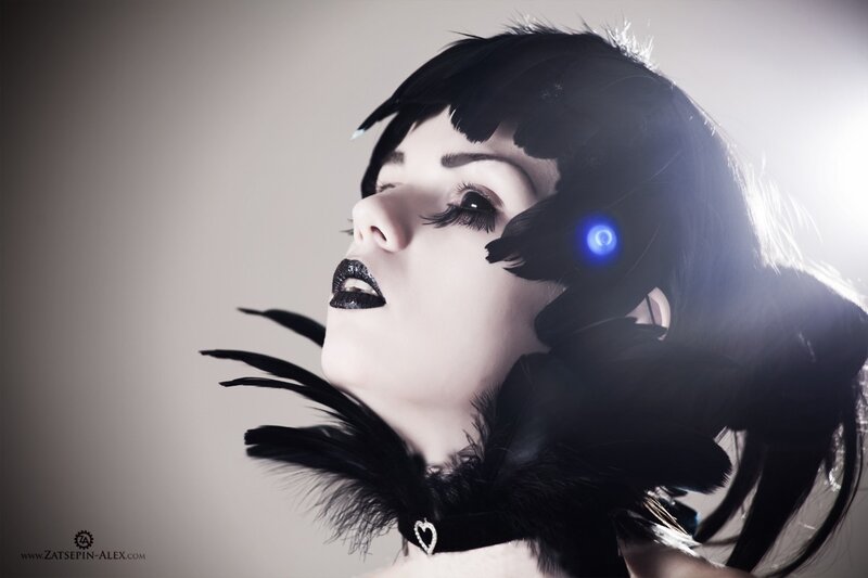 woman with black feathers and blue light