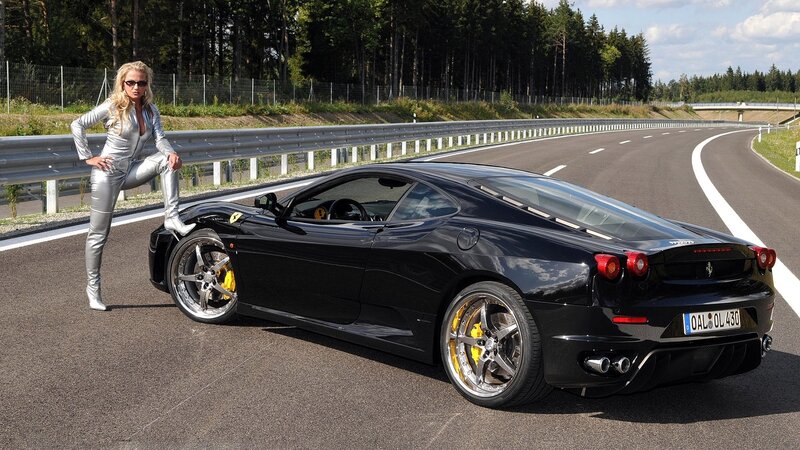 Woman with black Ferrari on track